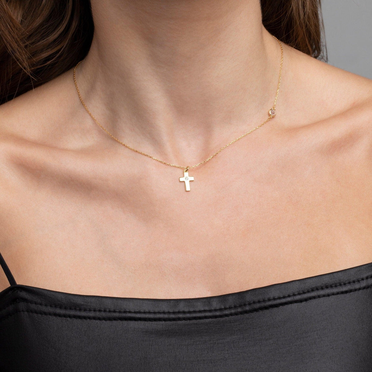 Close detail of the Small Cross Necklace with Diamond in 18K Gold Vermeil with CZ Diamond. Safe for sensitive skin, premium.