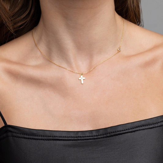 Close detail of the Small Cross Necklace with Diamond in 18K Gold Vermeil with CZ Diamond. Safe for sensitive skin, premium.