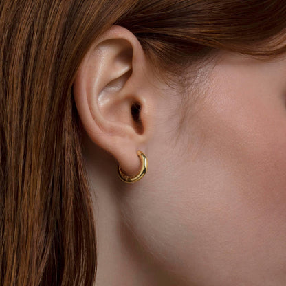 Close detail of the Small Huggie Hoops Earrings in 18K Gold Vermeil. Tarnish-resistant, premium handmade jewelry.