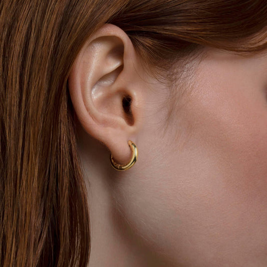 Close detail of the Small Huggie Hoops Earrings in 18K Gold Vermeil. Tarnish-resistant, premium handmade jewelry.