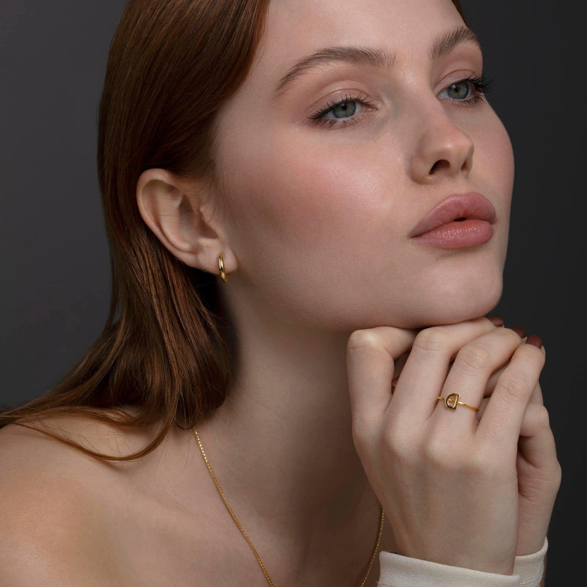 The Small Huggie Hoops Earrings styled in 18K Gold Vermeil — elegant everyday jewelry. Hypoallergenic for sensitive ears.