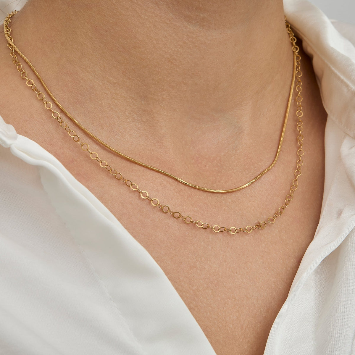 Layered chain necklace look with the gold snake chain