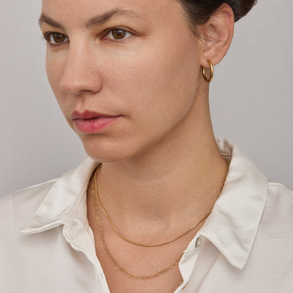 Gold snake chain necklace worn on the neck