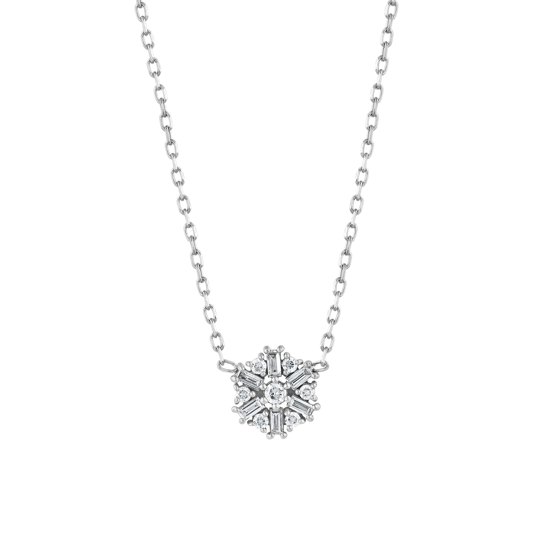 Close view of the snowflake motif: six baguette diamonds radiating around a central round brilliant in 14K white gold