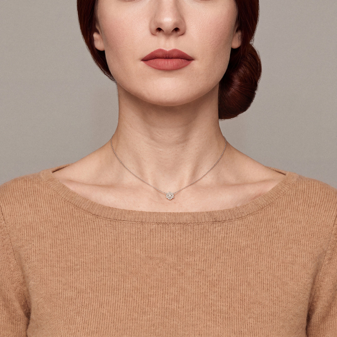 Model in a camel cashmere boat-neck sweater wearing the snowflake baguette natural diamond necklace in 14K solid white gold
