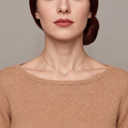 Model in a camel cashmere boat-neck sweater wearing the snowflake baguette natural diamond necklace in 14K solid white gold