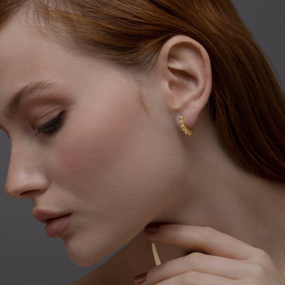 The Spike Huggie Earring styled in 18K Gold Vermeil — elegant everyday jewelry. Hypoallergenic for sensitive ears.