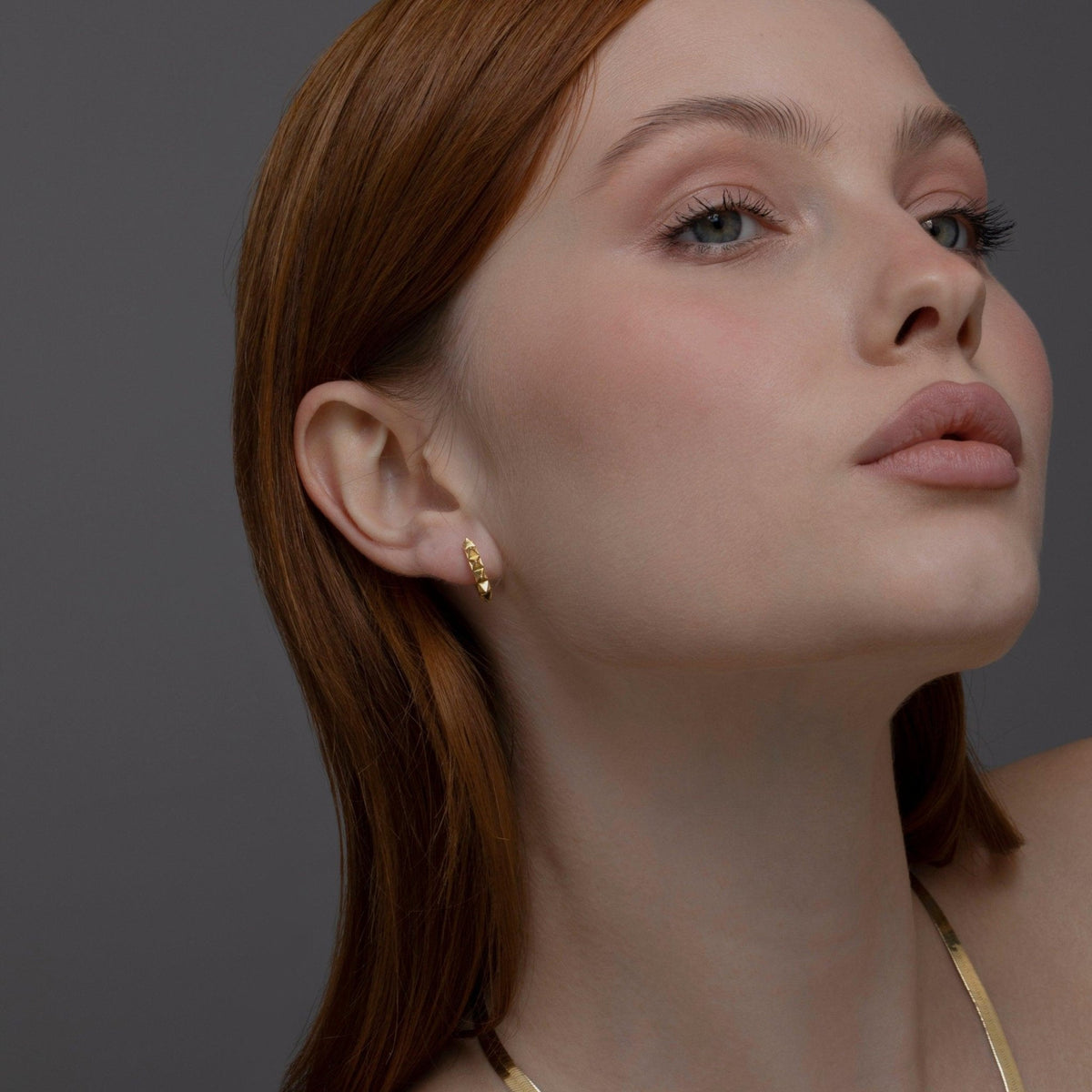 The Spike Huggie Earring worn in 18K Gold Vermeil — refined accessory for women. Tarnish-resistant.