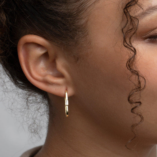Close detail of the Square Hoop Earrings with Baguette Diamond in 18K Gold Vermeil with CZ Diamond. Tarnish-resistant.