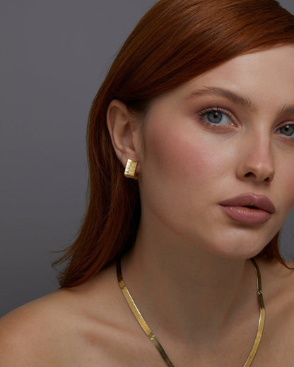 The Square Hoop Huggie Earrings styled in 18K Gold Vermeil — elegant everyday jewelry. Hypoallergenic for sensitive ears.