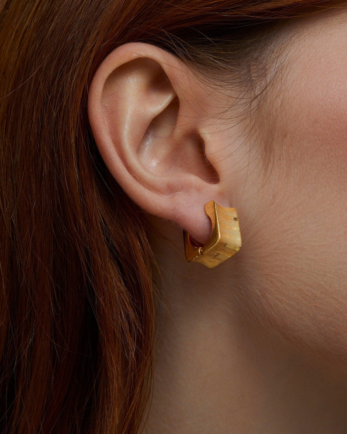 Square Hoop Huggie Earrings styled with complementary pieces in 18K Gold Vermeil. Hypoallergenic for sensitive ears.