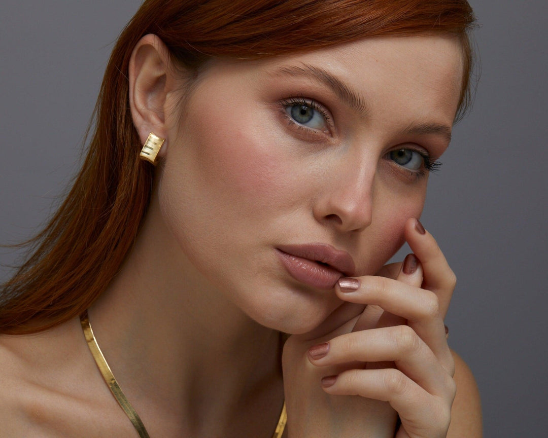 The Square Hoop Huggie Earrings worn in 18K Gold Vermeil — refined accessory for women. Tarnish-resistant.