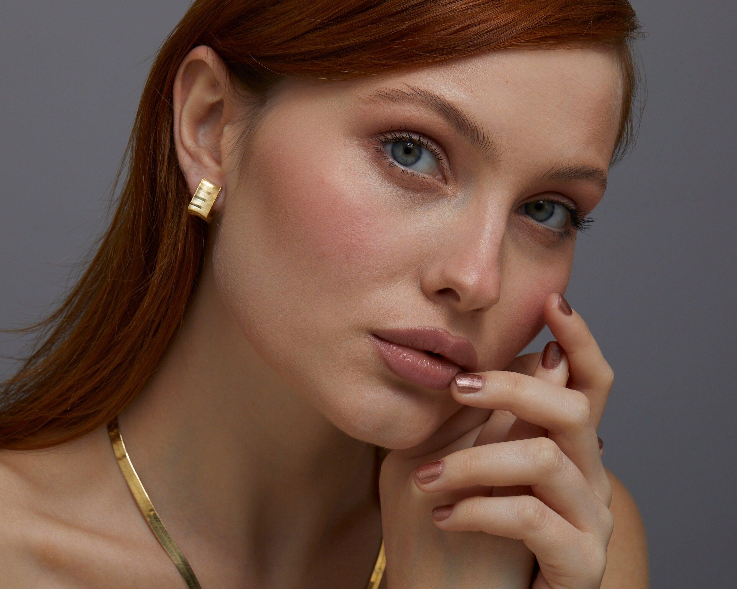 The Square Hoop Huggie Earrings worn in 18K Gold Vermeil — refined accessory for women. Tarnish-resistant.