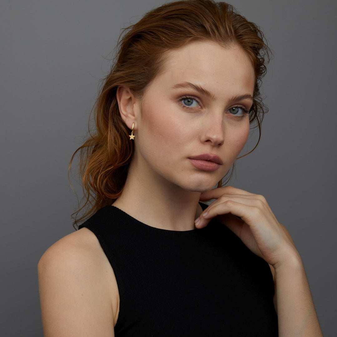 The Star Hoop Earrings styled in 18K Gold Vermeil — elegant everyday jewelry. Hypoallergenic for sensitive ears.