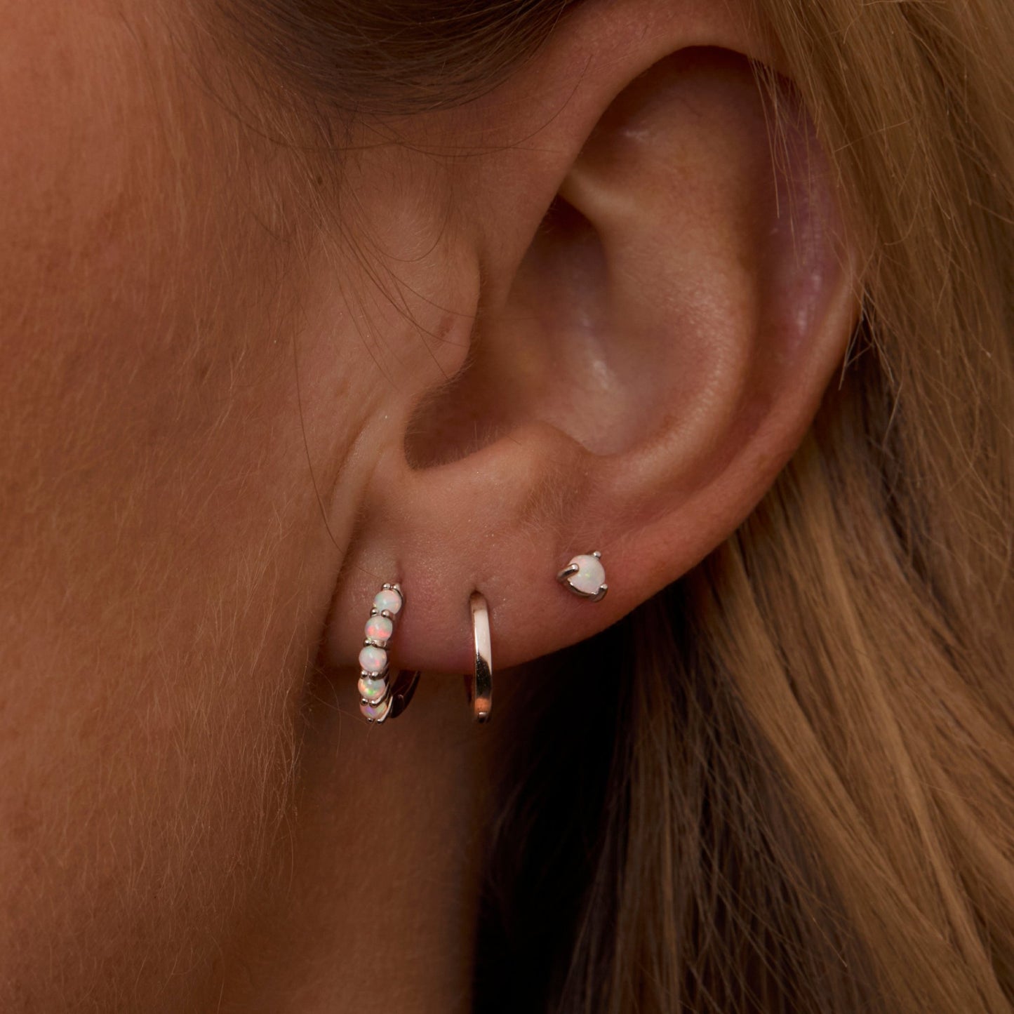 Macro detail of the Sterling Silver Opal Earring Set: Opal set in 18K Gold Vermeil. No green marks, handmade jewelry.