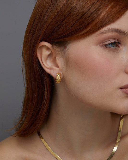 Close detail of the Textured Hinged Huggie Hoop Earrings in 18K Gold Vermeil. Tarnish-resistant, premium handmade jewelry.