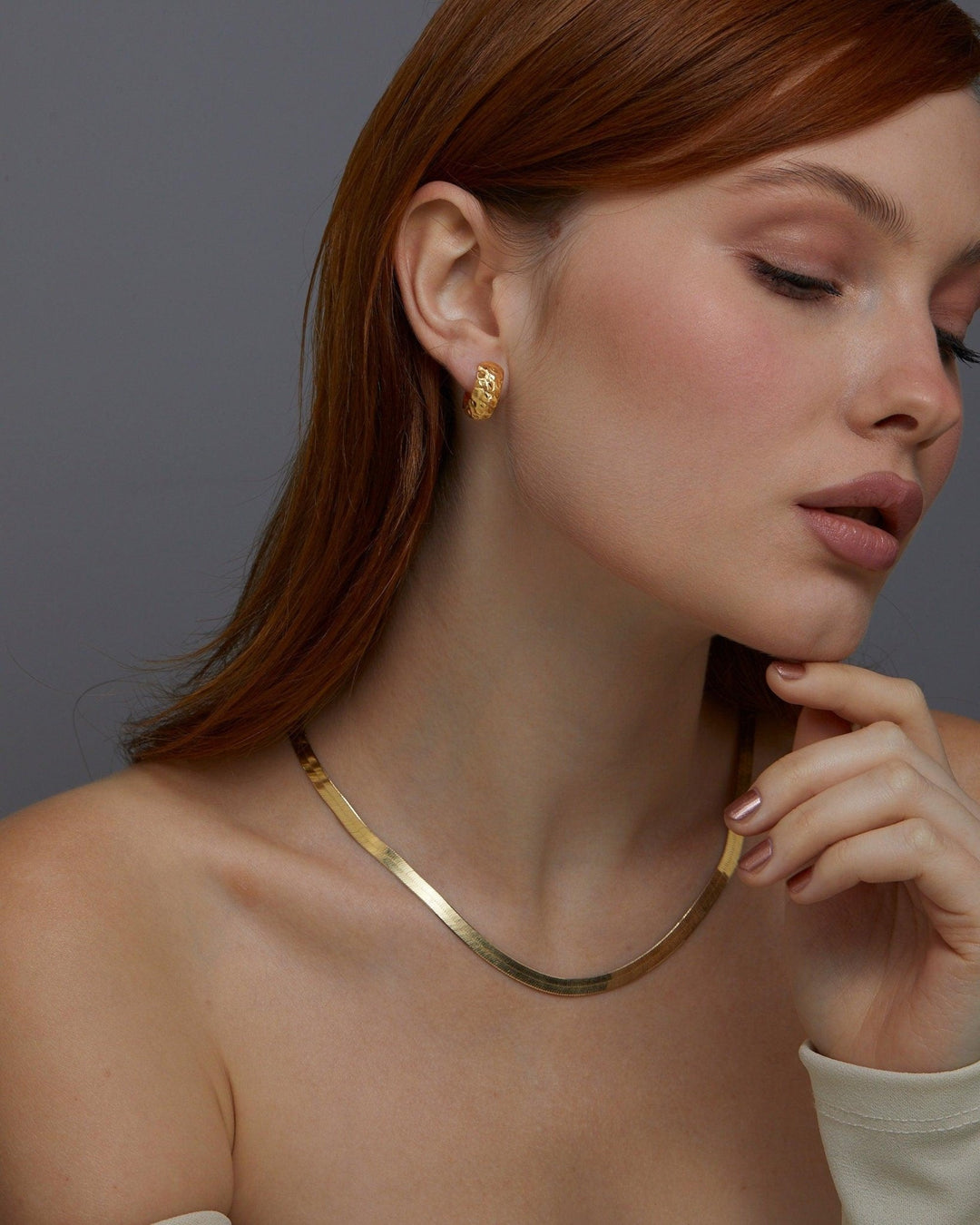 Macro detail of the Textured Hinged Huggie Hoop Earrings showcasing craftsmanship in 18K Gold Vermeil. No green marks.