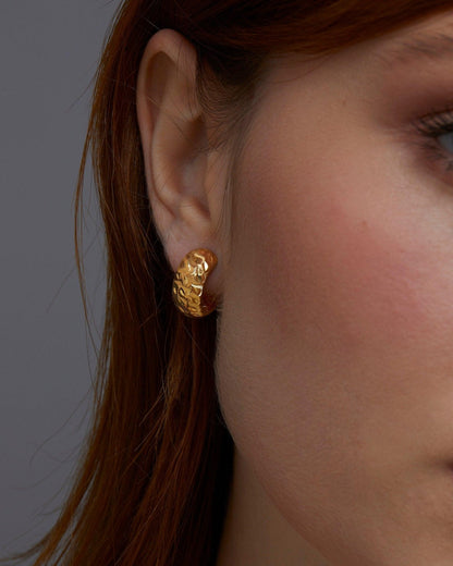 The Textured Hinged Huggie Hoop Earrings worn in 18K Gold Vermeil — refined accessory for women. Tarnish-resistant.