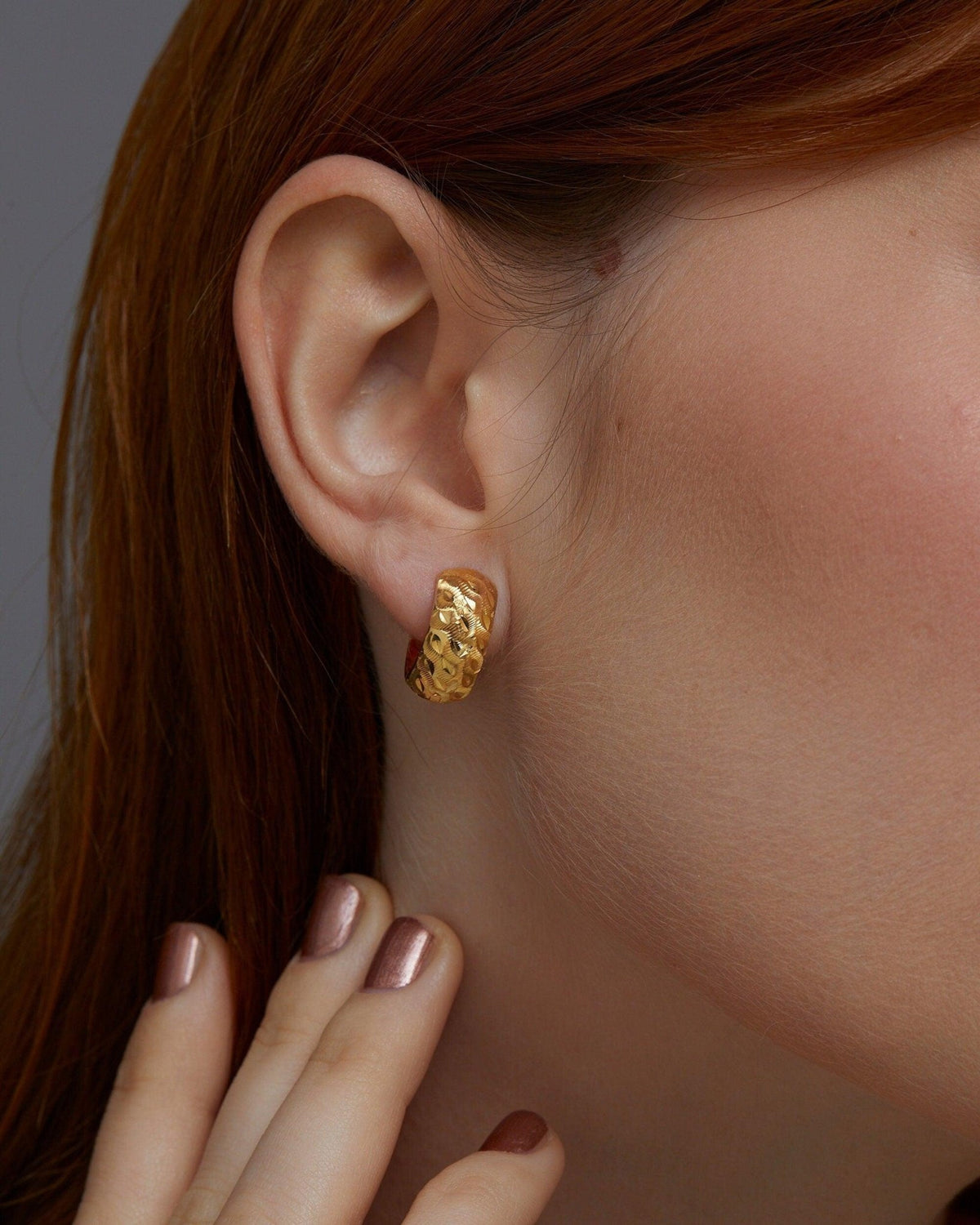 The Textured Hinged Huggie Hoop Earrings styled in 18K Gold Vermeil — elegant everyday jewelry. Hypoallergenic.