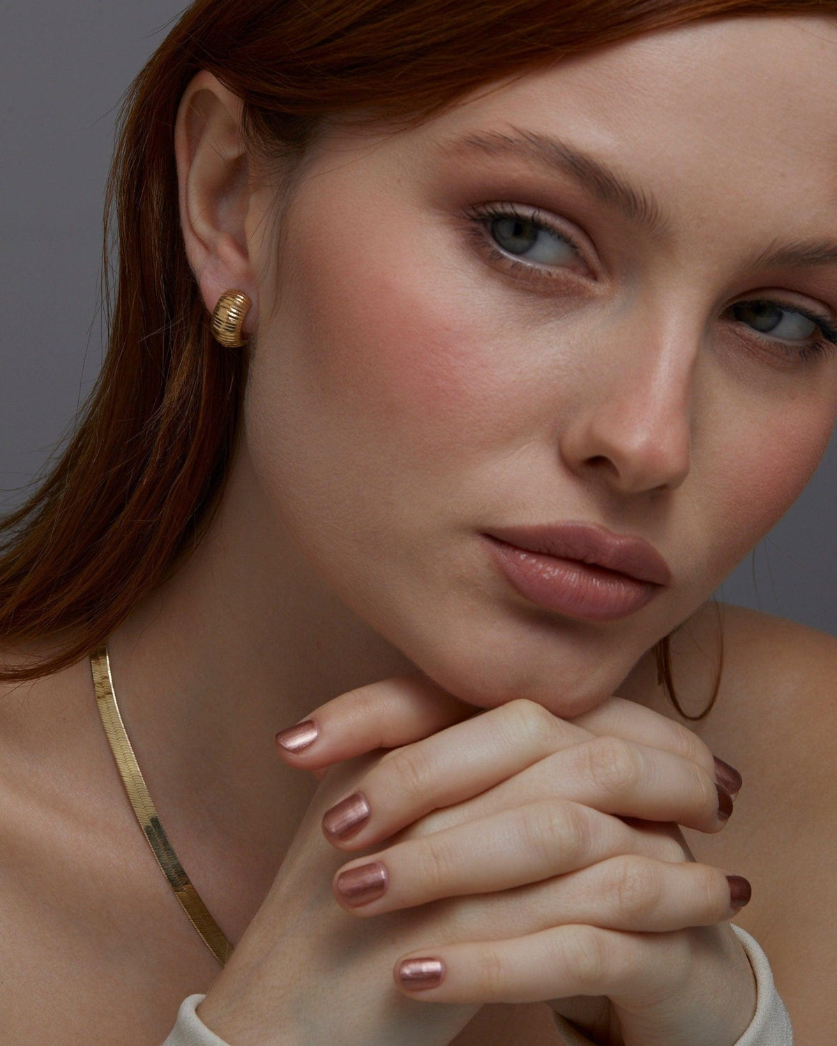 The Textured Huggie Earrings styled in 18K Gold Vermeil — elegant everyday jewelry. Hypoallergenic for sensitive ears.