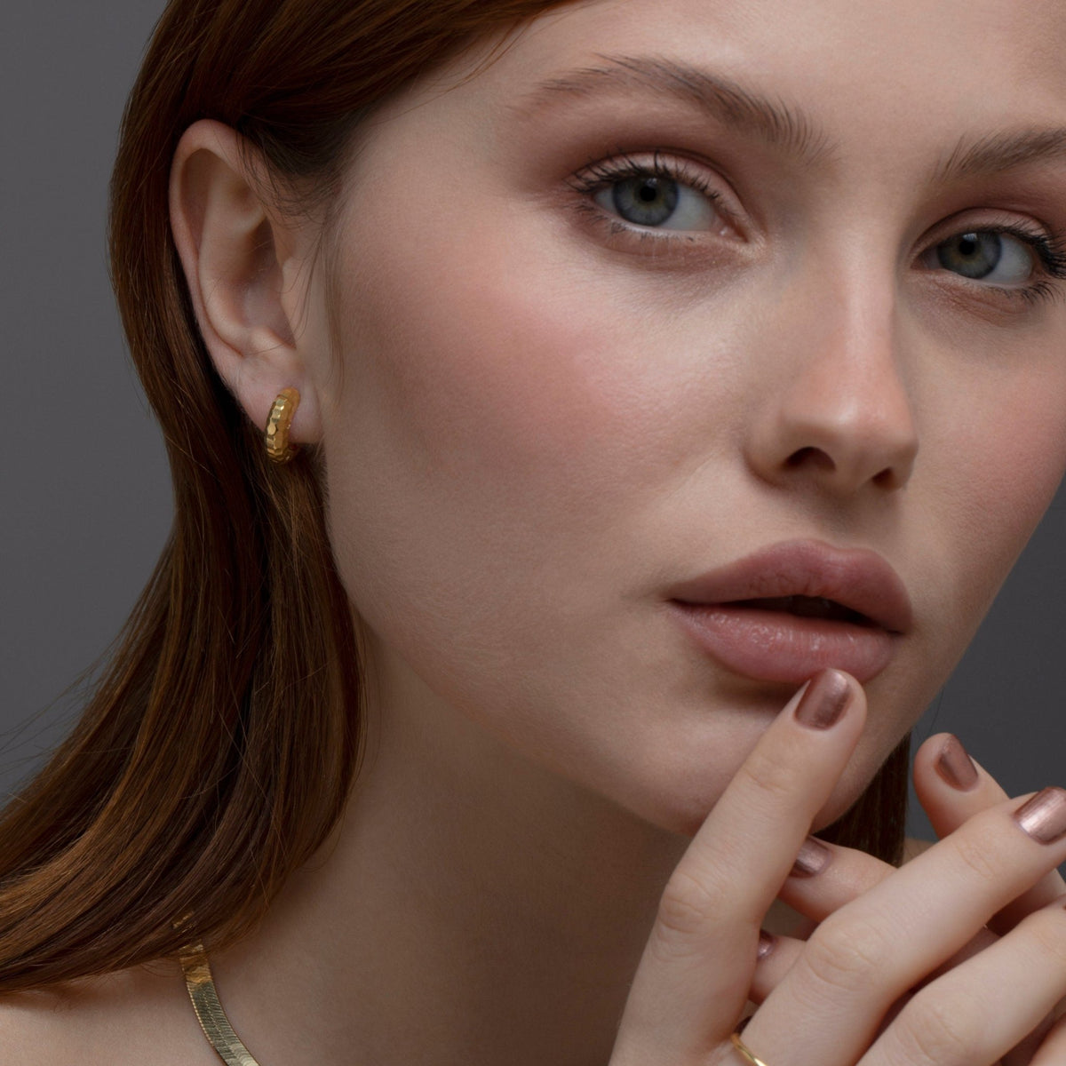 The Textured Huggie Hoop Earrings styled in 18K Gold Vermeil — elegant everyday jewelry. Hypoallergenic for sensitive ears.