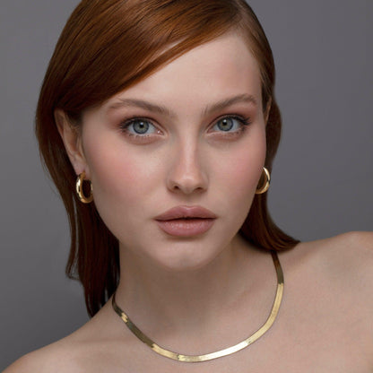 The Thick Hoop Earrings styled in 18K Gold Vermeil — elegant everyday jewelry. Hypoallergenic for sensitive ears.