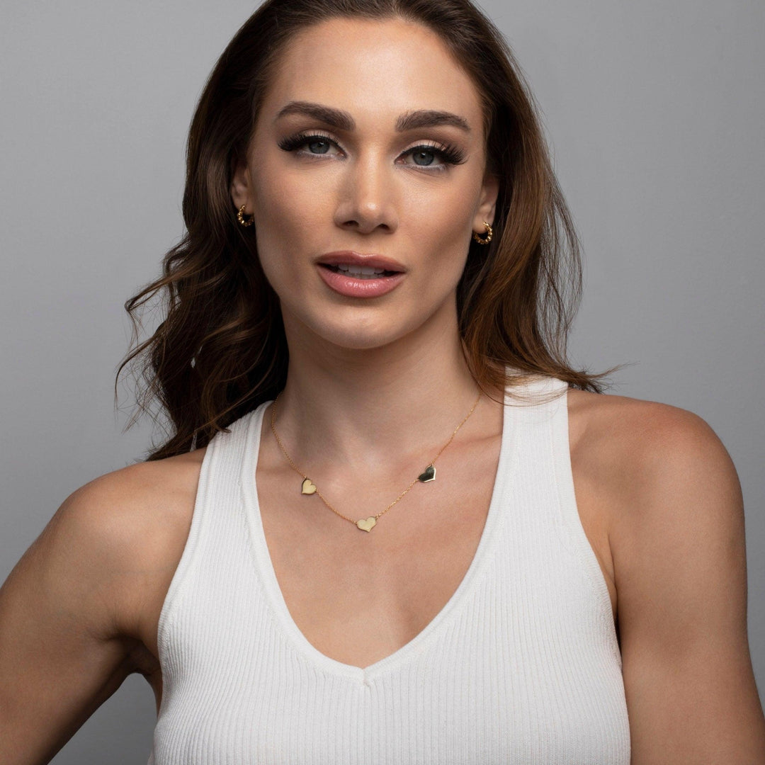 The Triple Heart Necklace styled in 18K Gold Vermeil — elegant everyday jewelry. Tarnish-resistant.
