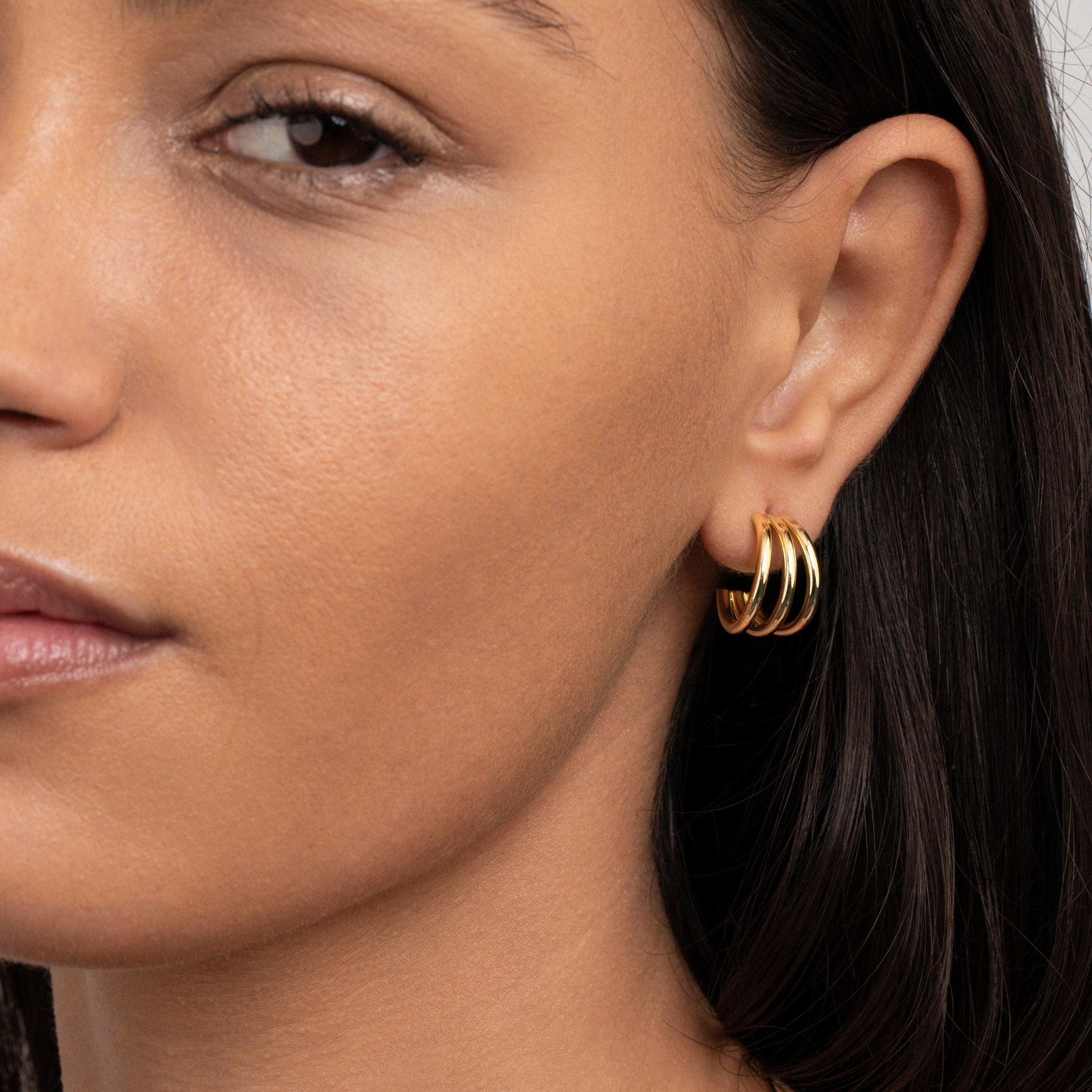 The Gold Triple Hoop Earrings styled in Gold-Plated Steel — elegant everyday jewelry. Hypoallergenic for sensitive ears.