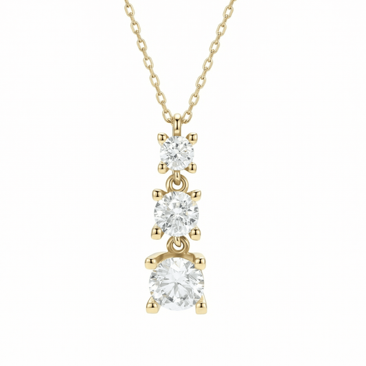 Triple stone necklace in 14K solid gold: three graduated round CZ stones, each in a four-prong setting, on a fine chain against a white background.
