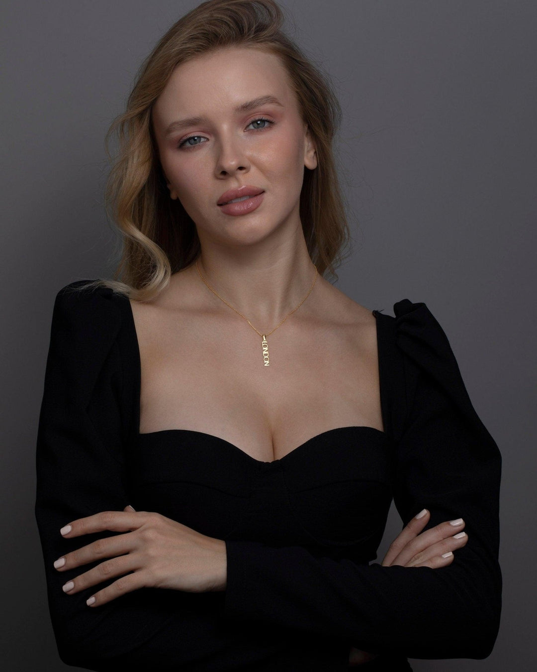 The Vertical Name Necklace styled in 18K Gold Vermeil — elegant everyday jewelry. Hypoallergenic, no green marks.